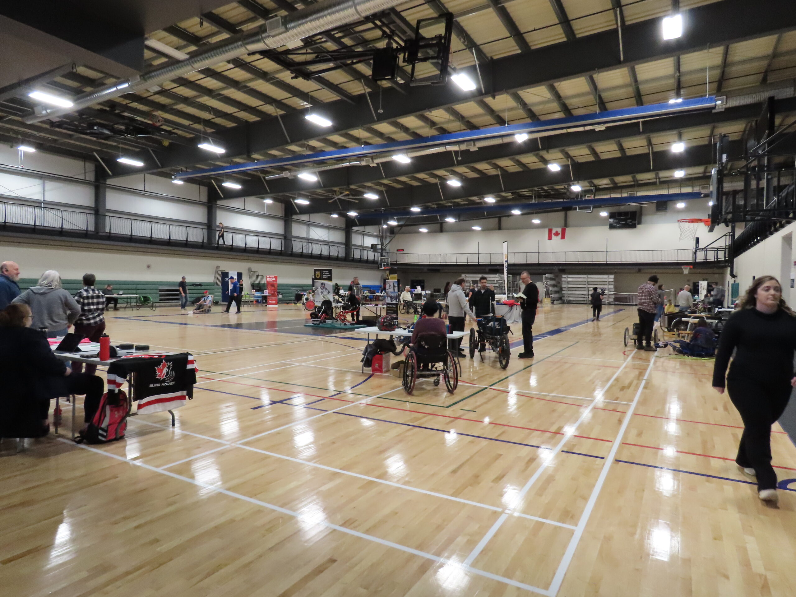 A wide angle view of the expo, gym space in action. All the organizations have a visitor and the even is in full swing!